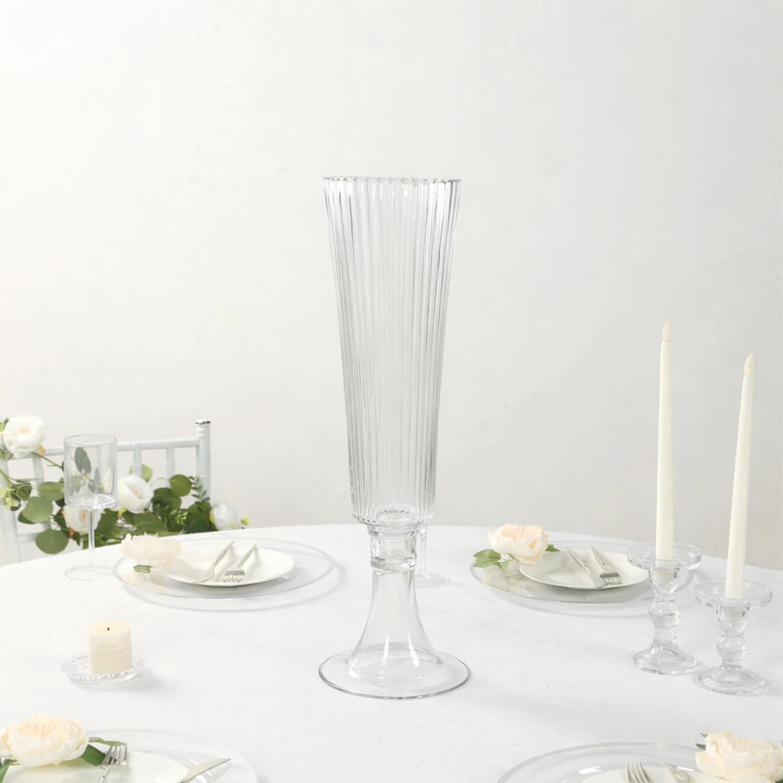 Clear ribbed glass trumpet vase for elegant flower centerpieces.