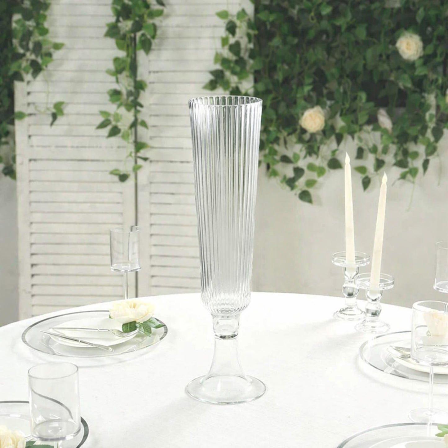 Clear ribbed glass trumpet vase, perfect for event centerpieces.