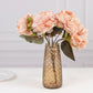 Amber gold crystal cut vase with pink flowers, perfect for decorative centerpieces.