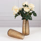 Amber gold decorative flower vases with roses, elegant table centerpieces.