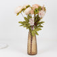 Amber gold diamond crystal cut vase with floral arrangement.