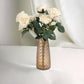 Amber gold crystal cut vase with roses, elegant table centerpiece.
