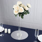 Clear glass Eiffel Tower vase with white roses, perfect for centerpieces.