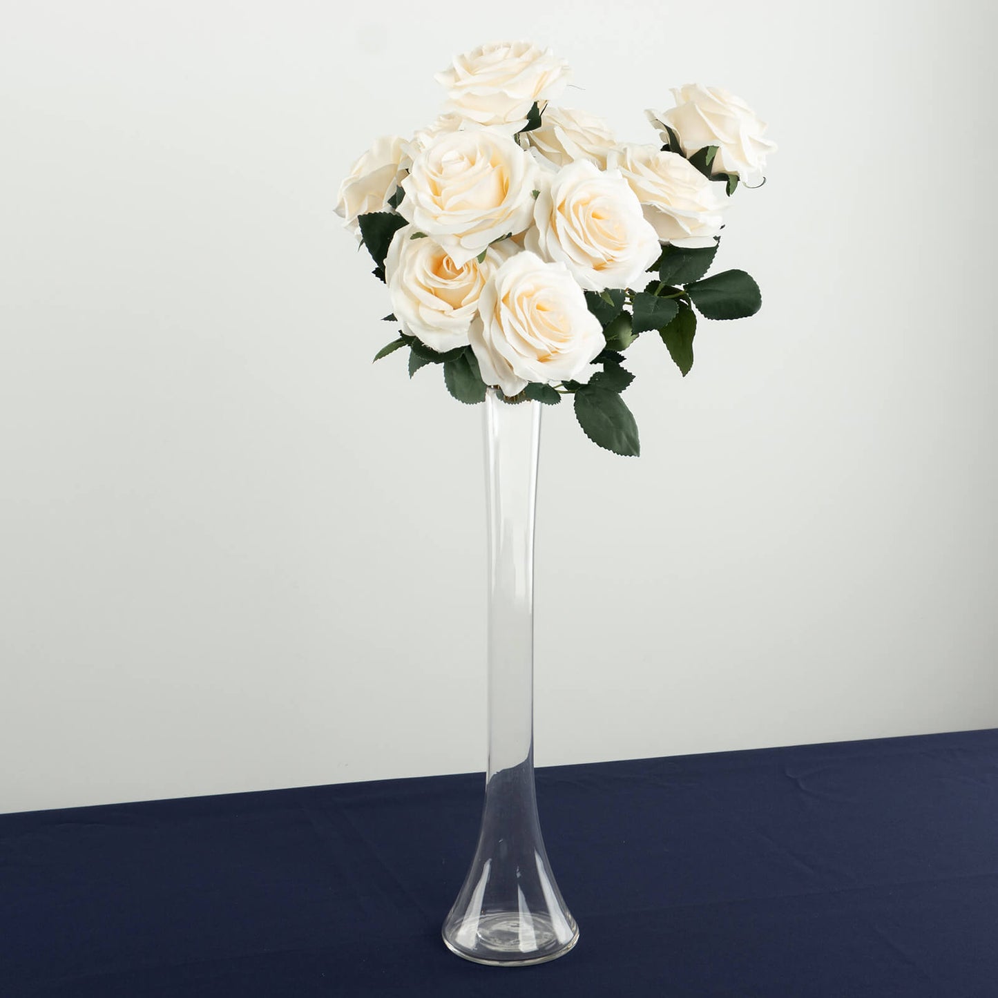 Clear glass Eiffel Tower vase with white roses, 16" tall centerpiece.