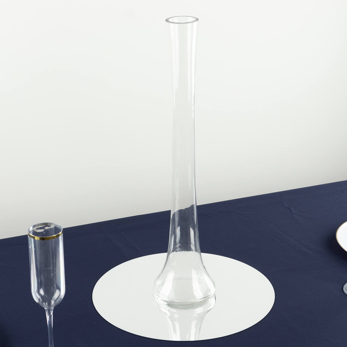 Clear glass Eiffel Tower vase, 20" tall, round base, perfect for floral centerpieces.