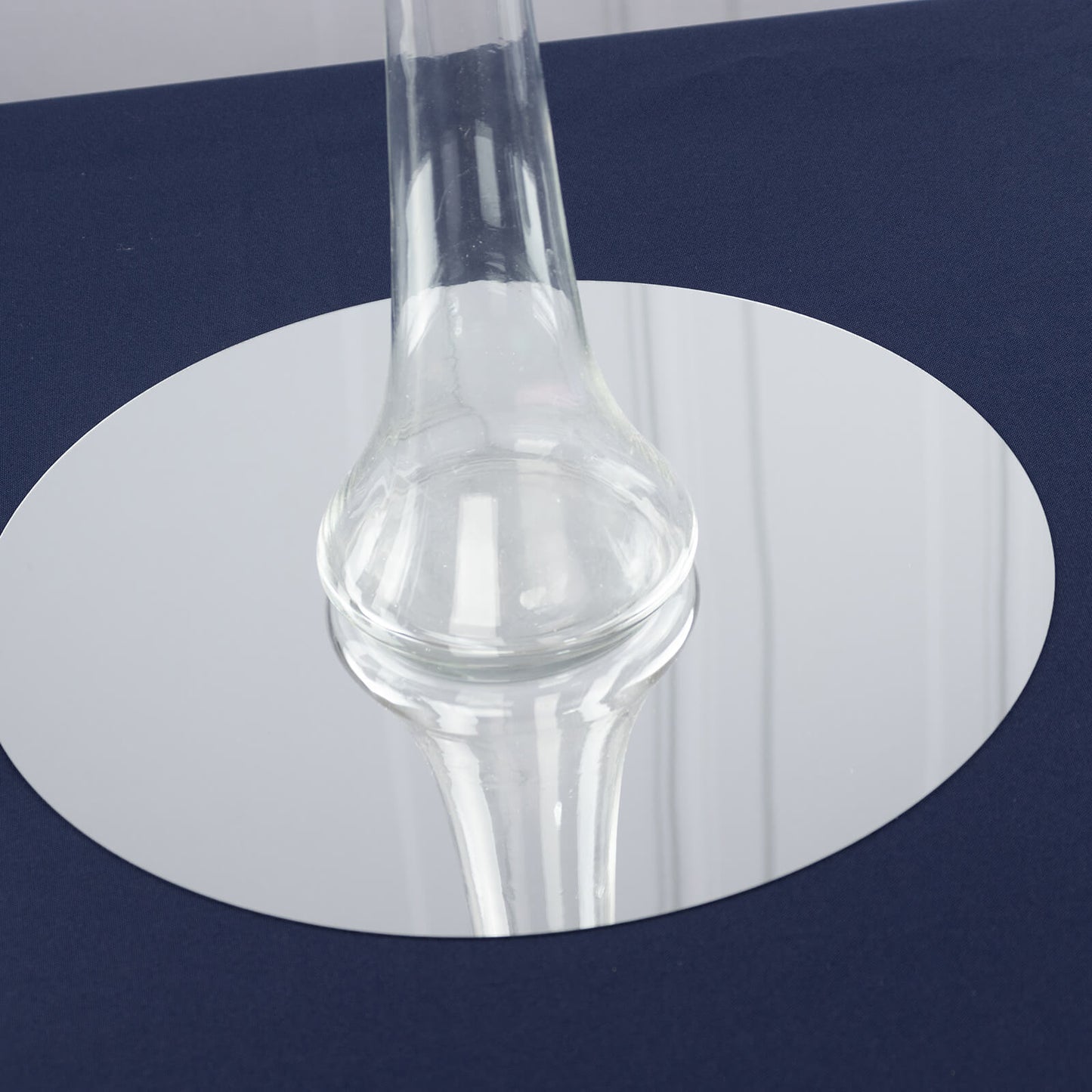 Clear heavy-duty glass Eiffel Tower vase on a round base.