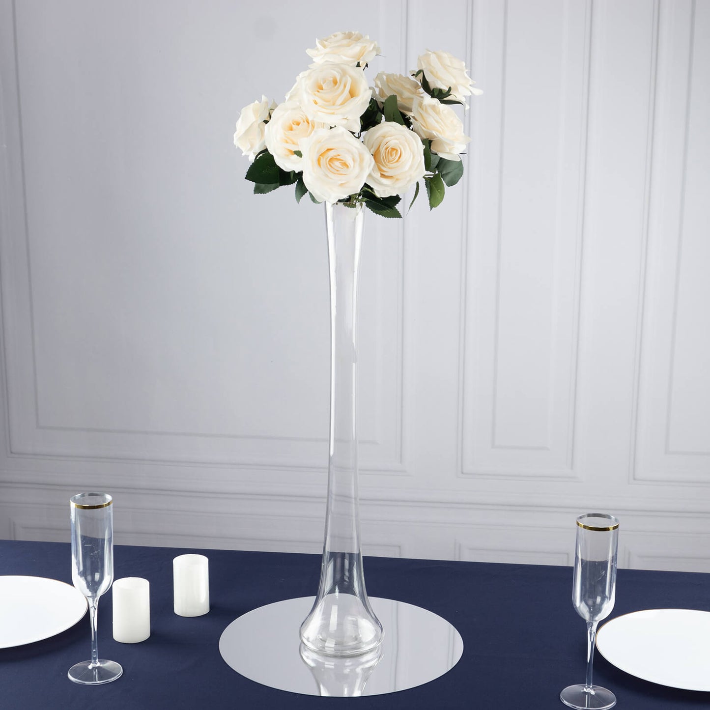 Clear glass Eiffel Tower vase with white roses, 24" tall centerpiece.