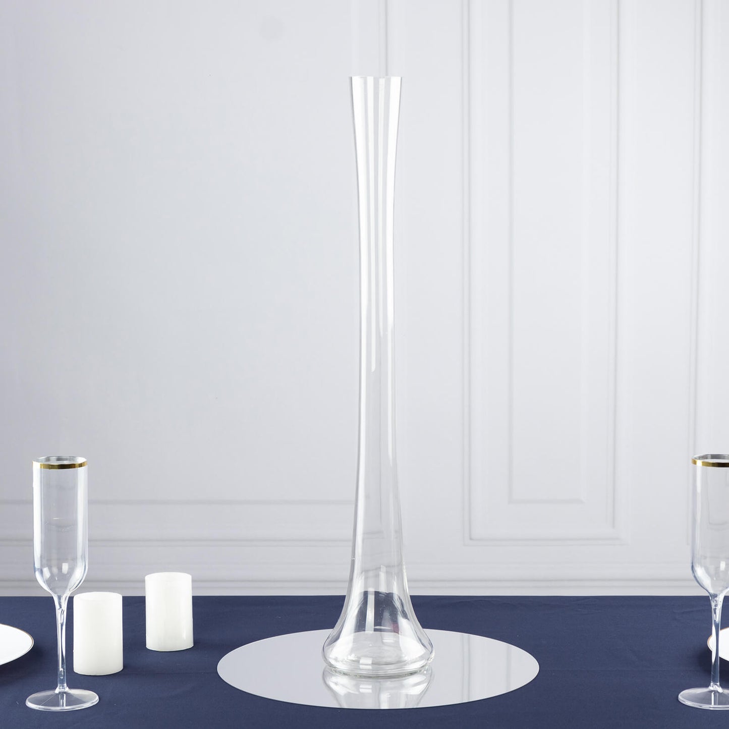 Clear heavy-duty glass Eiffel Tower vase, 24" tall, on a navy blue table setting.