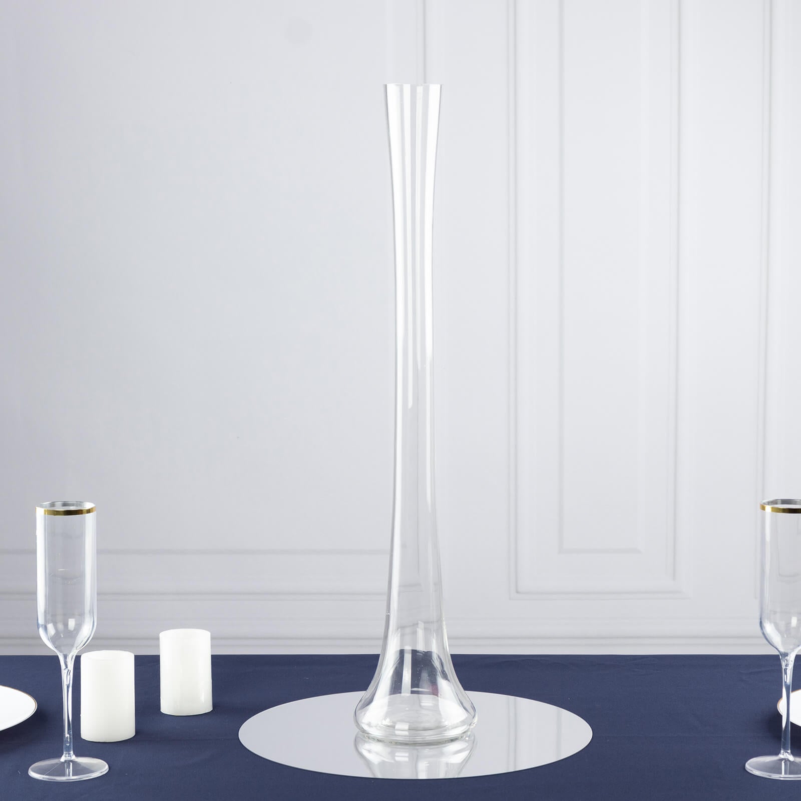 Clear heavy-duty glass Eiffel Tower vase, 24" tall, on a navy blue table setting.