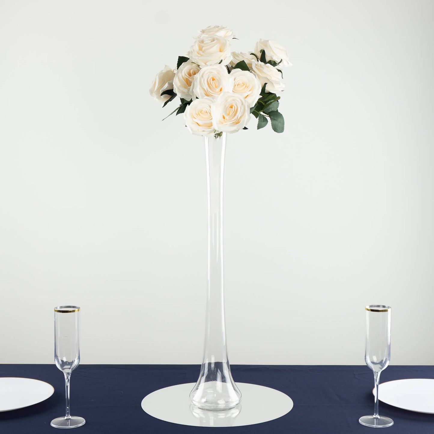 Clear glass Eiffel Tower vase with white roses, 24" tall centerpiece.