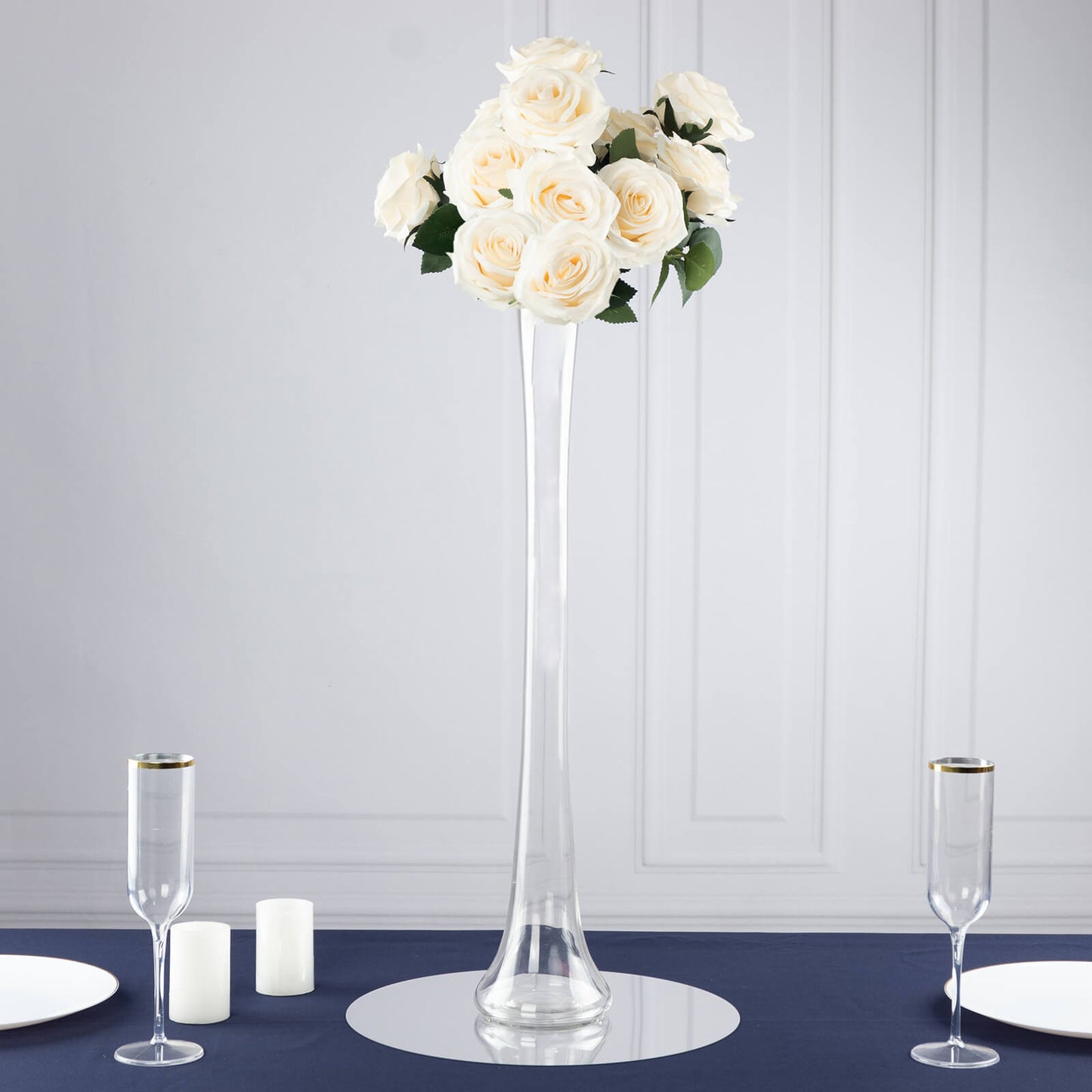 Clear heavy duty glass Eiffel Tower vase with white roses centerpiece.