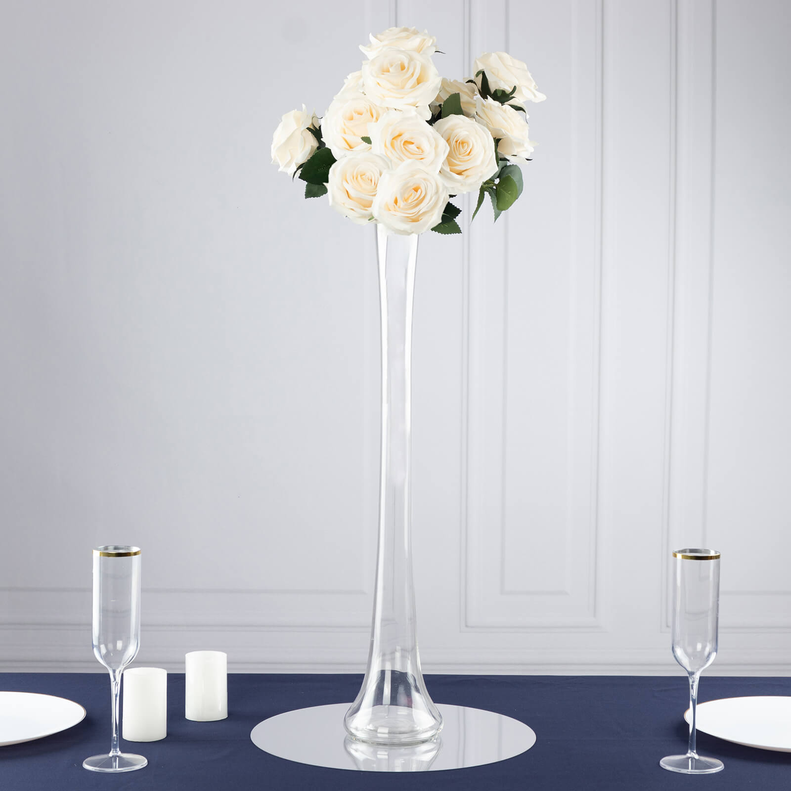 Clear heavy duty glass Eiffel Tower vase with white roses centerpiece.