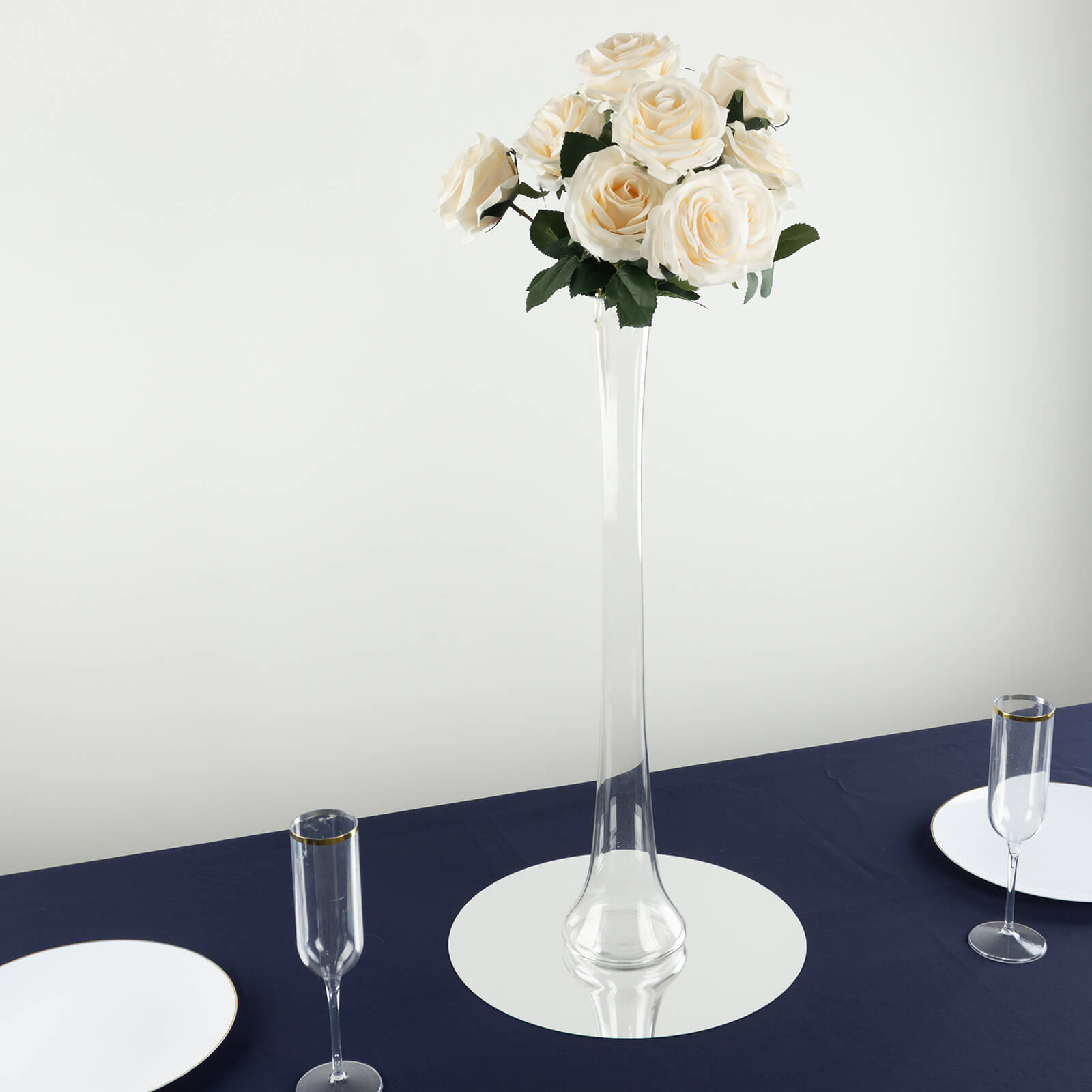 Clear heavy duty glass Eiffel Tower vase with white roses centerpiece.