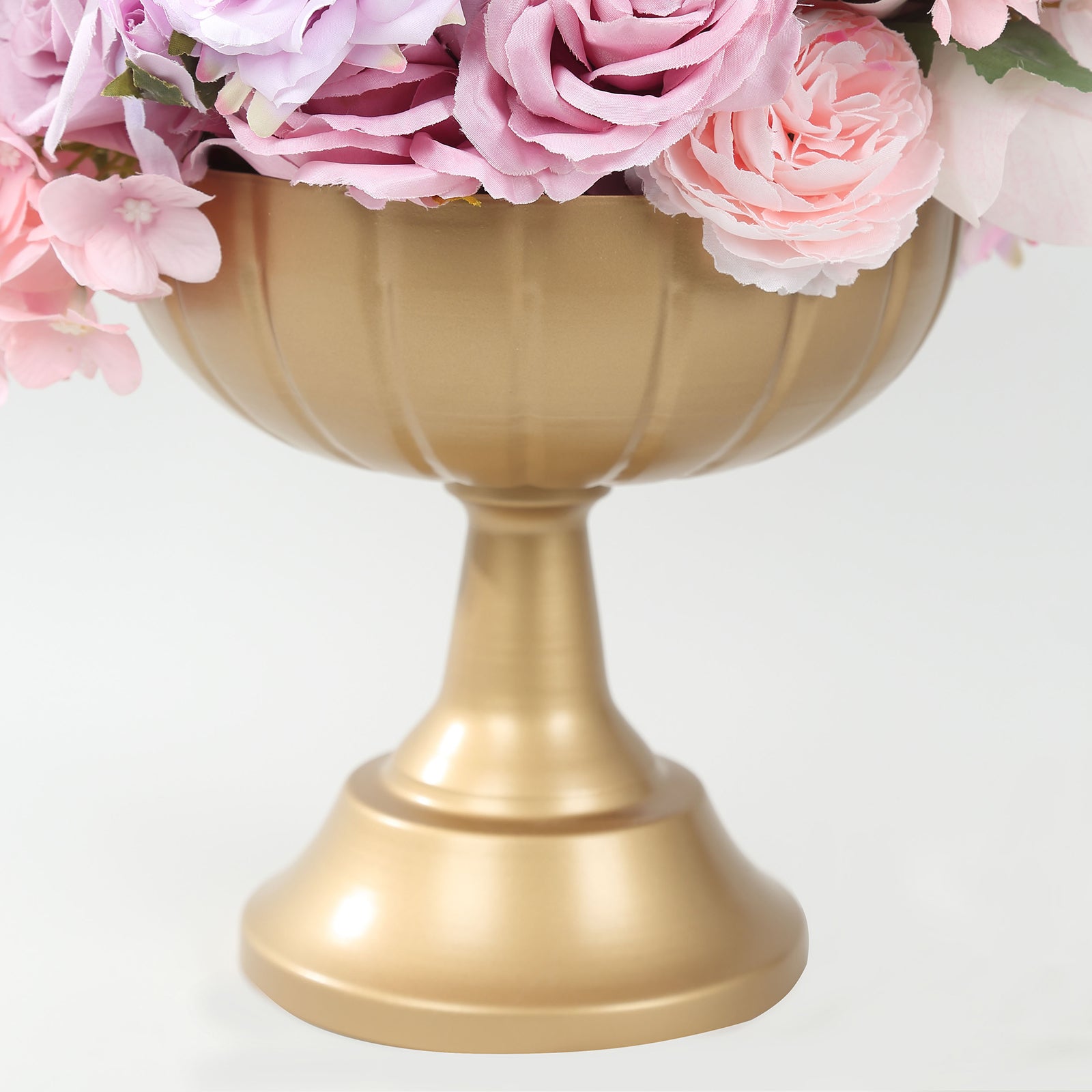 Gold metal compote pedestal bowl vase with flowers in a Grecian urn style.