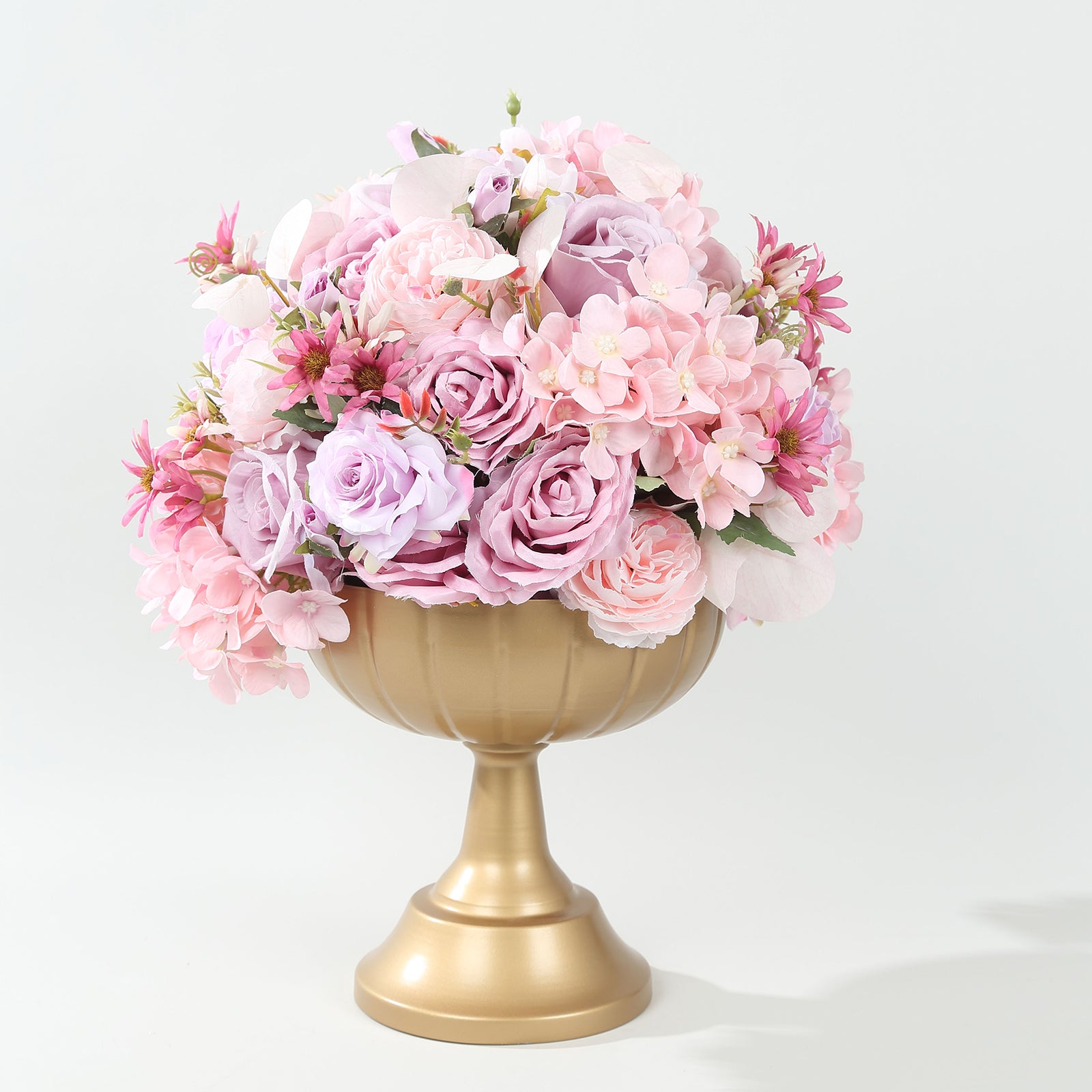 Gold metal compote pedestal bowl vase with pink floral arrangement.