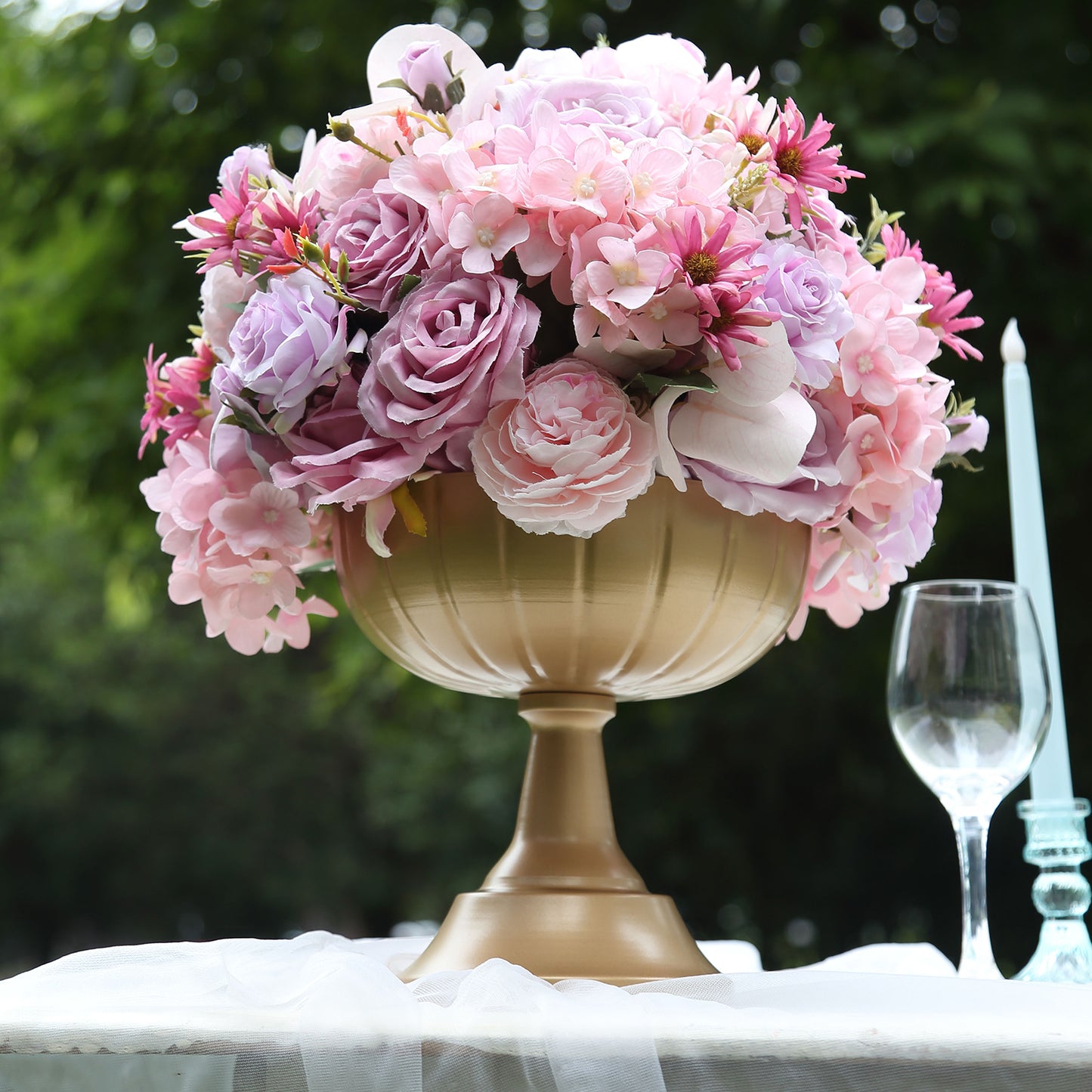 Gold compote pedestal bowl vase with pink and purple flowers.