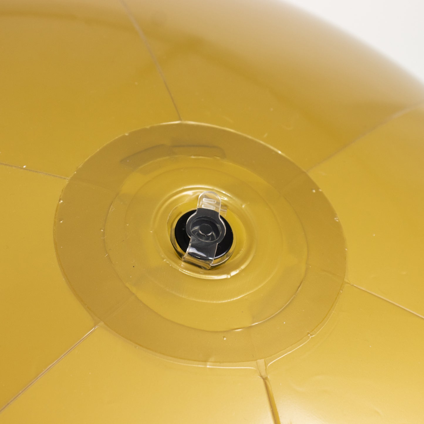 Inflatable gold decorative ball with a valve for easy inflation.