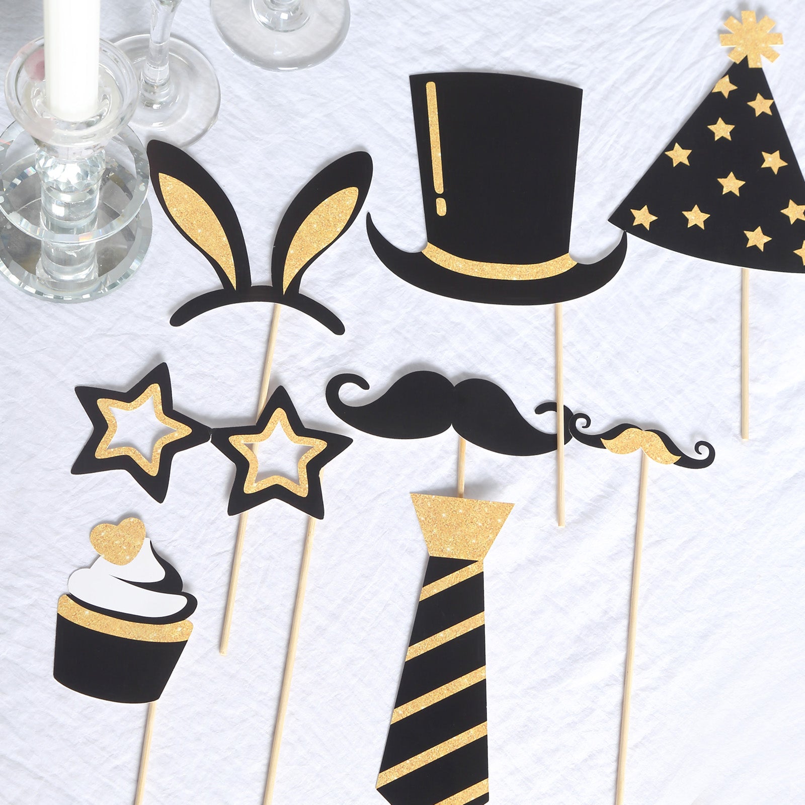 Vintage black and gold glitter photo booth props for party fun.