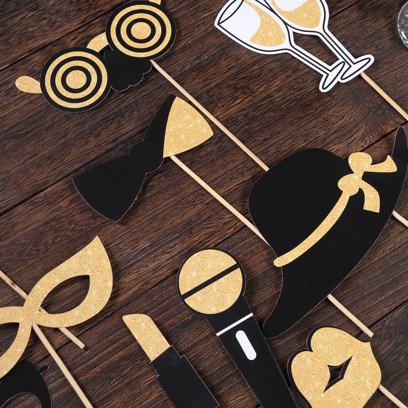 Vintage black and gold glitter photo booth props for party fun.