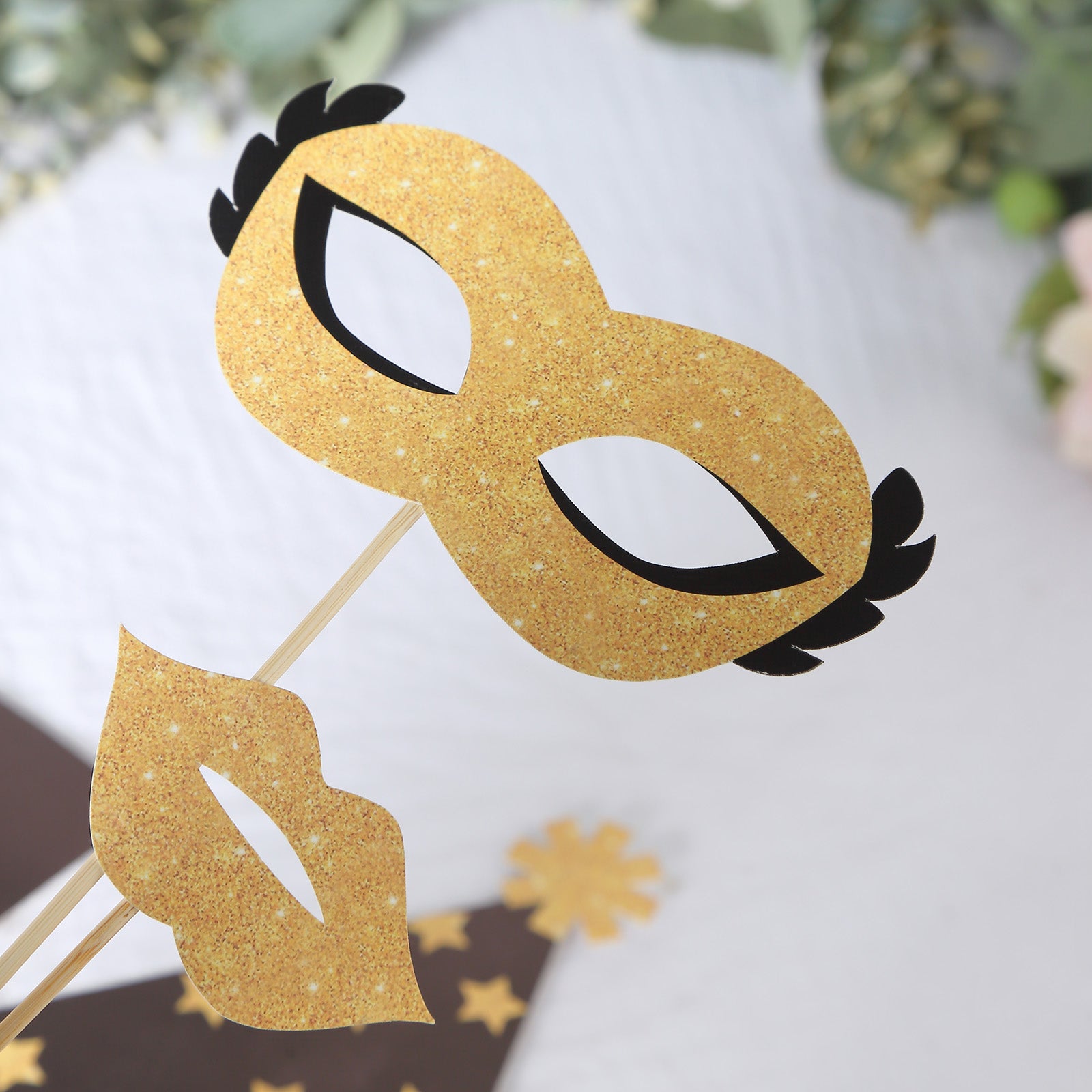 Gold glitter photo booth props for fun party themes.