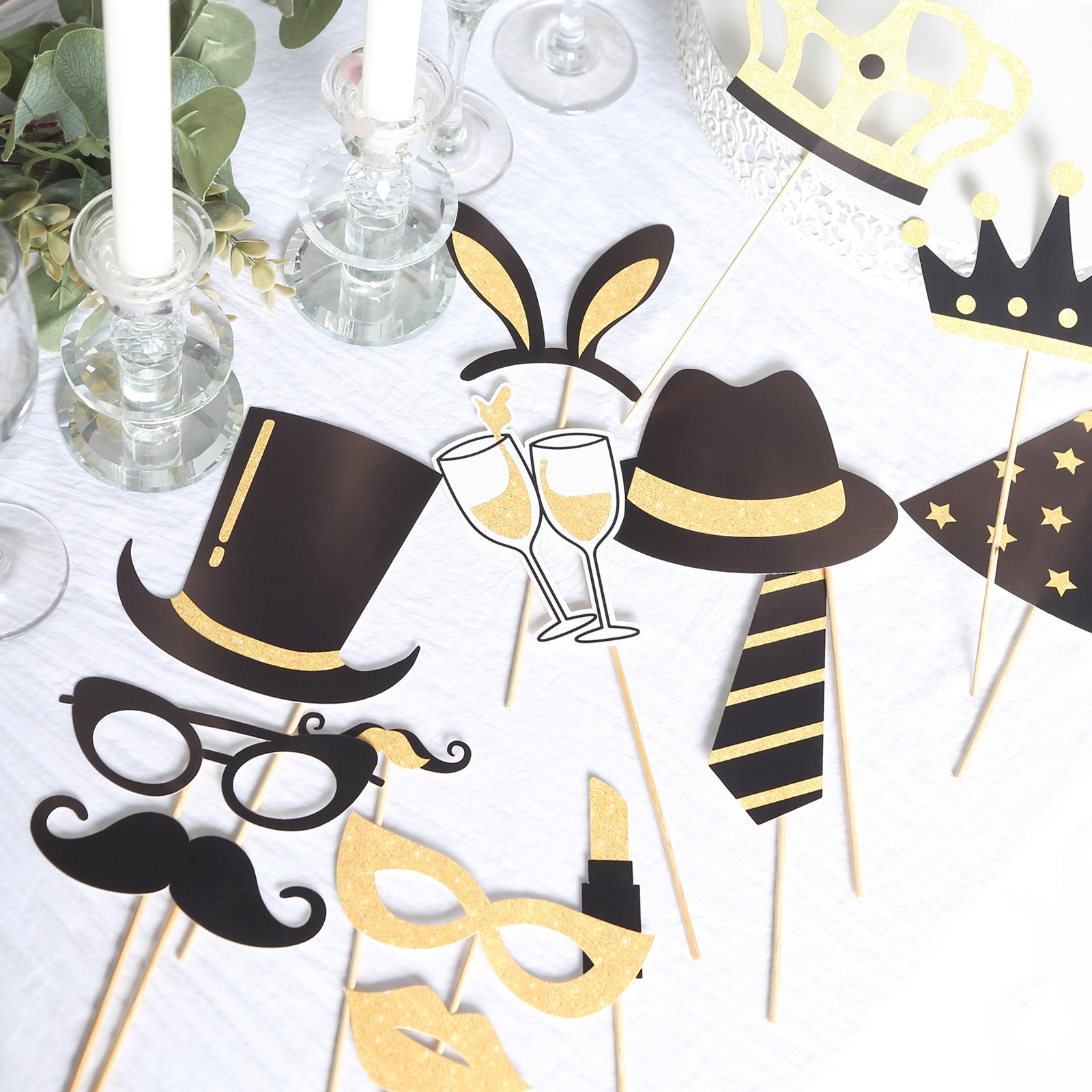 Vintage black and gold glitter photo booth props for parties.