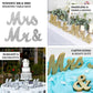 Silver glittered "Mr & Mrs" wooden photo props for rustic wedding table displays.
