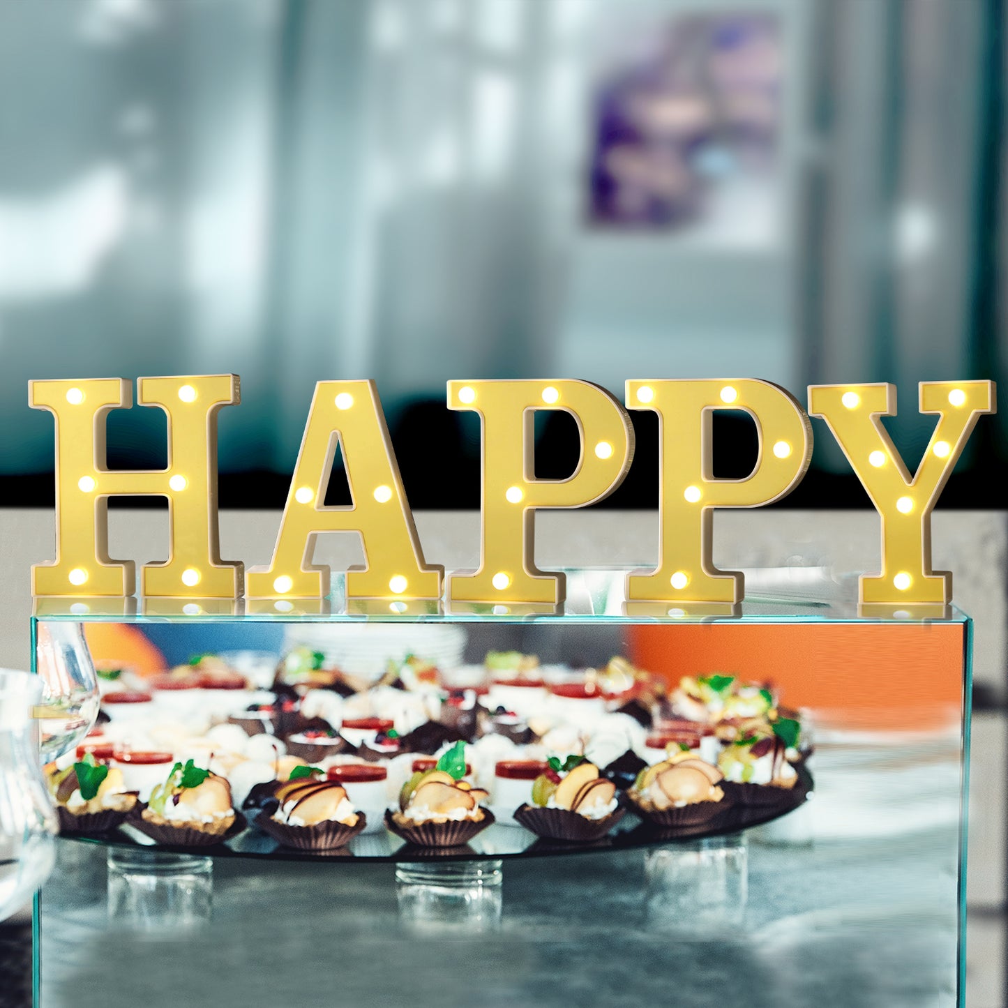 Gold 3D marquee letters "HAPPY" with warm white LED lights.