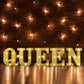 Gold 3D marquee letter "Q" with warm white LED lights.