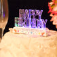 Clear acrylic multicolor LED Happy Birthday cake topper on a white cake.