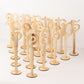 Natural wooden wedding table numbers set on sticks with round bases.