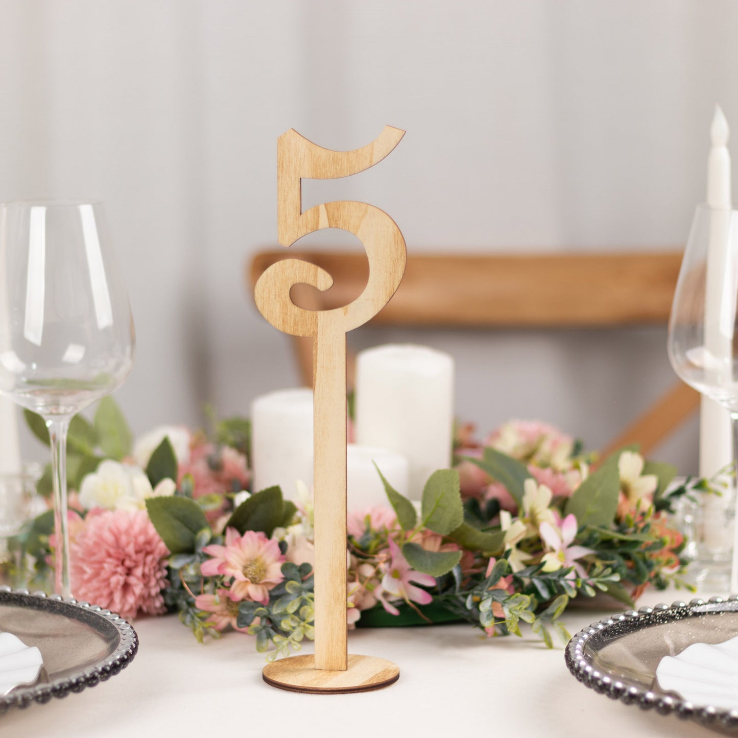 Natural wooden wedding table number 5 on a stick with round base.