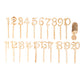 Natural wooden wedding table numbers set on sticks with round base.