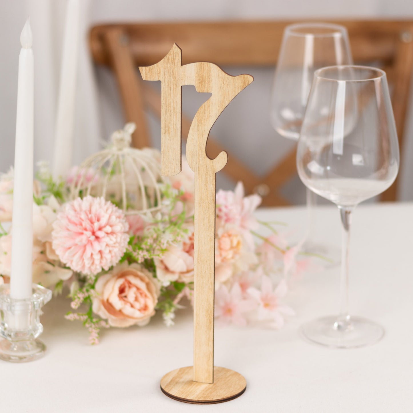Natural wooden table number sign 17 on stick with round base, rustic decor.