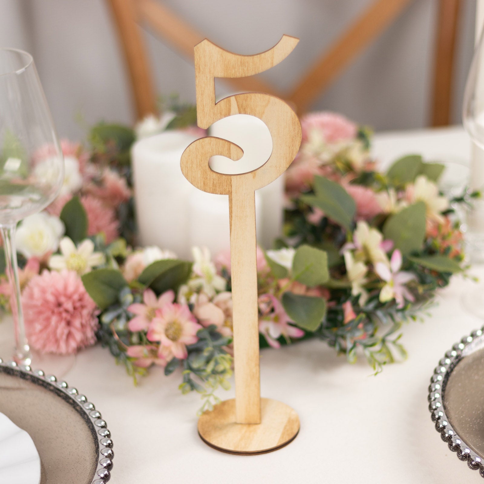 Natural wooden wedding table number on a stick with round base, 11" tall.