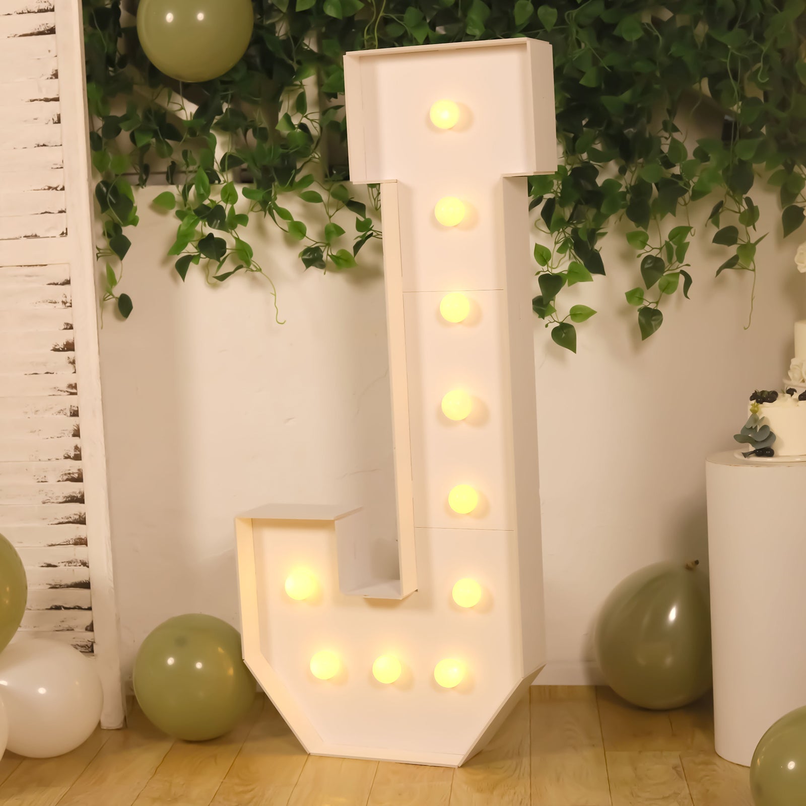 White LED marquee letter "J" illuminated with warm white lights.