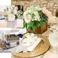 Whitewash square wood planter boxes with removable liners filled with flowers.