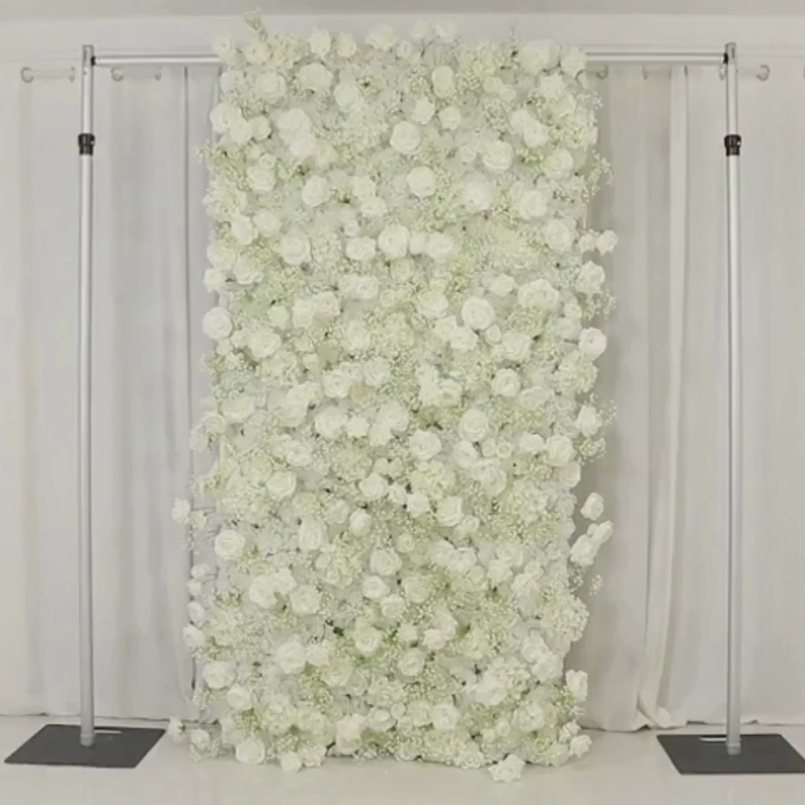 White silk roses and baby's breath artificial flower wall panel backdrop.