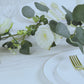 Lighted greenery garland with eucalyptus and peonies, primarily white.