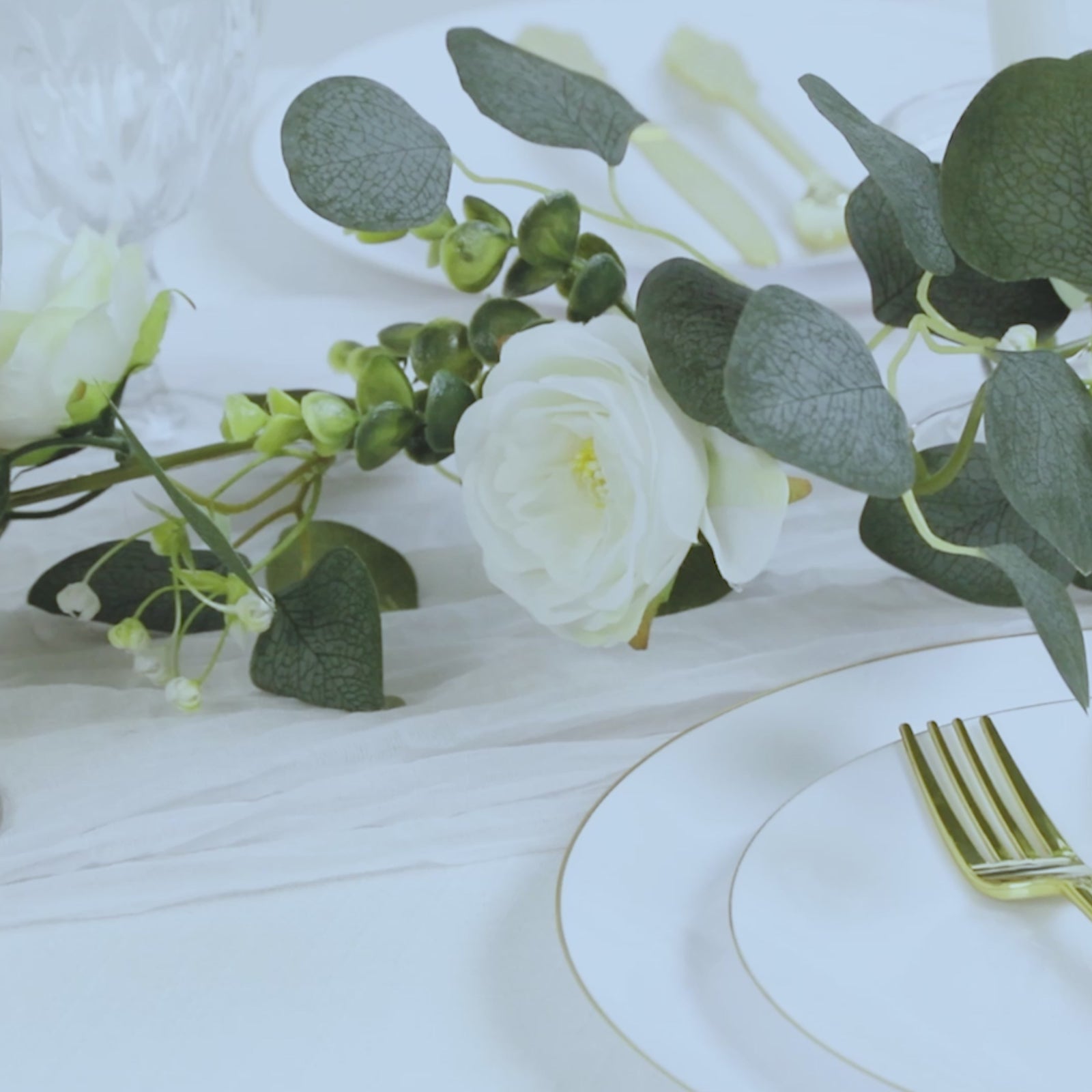 Lighted greenery garland with eucalyptus and peonies, primarily white.