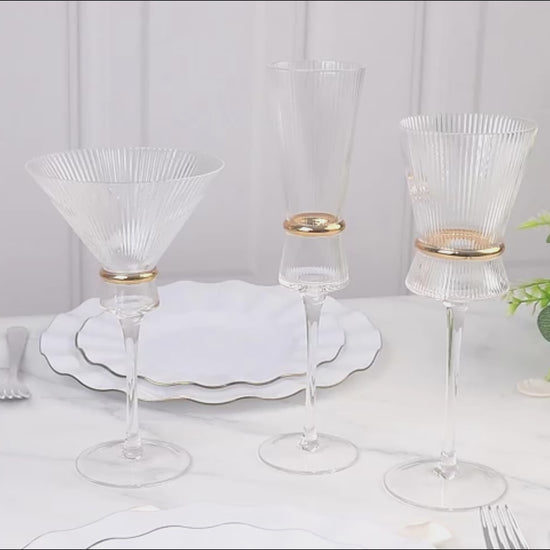 Clear champagne flutes with gold ring accents for elegant celebrations.