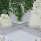 Silver cake stand with hanging crystal beads and glass top, perfect for desserts.