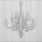 Silver glittered acrylic chandelier hanging decor with a 3D interlocking design.