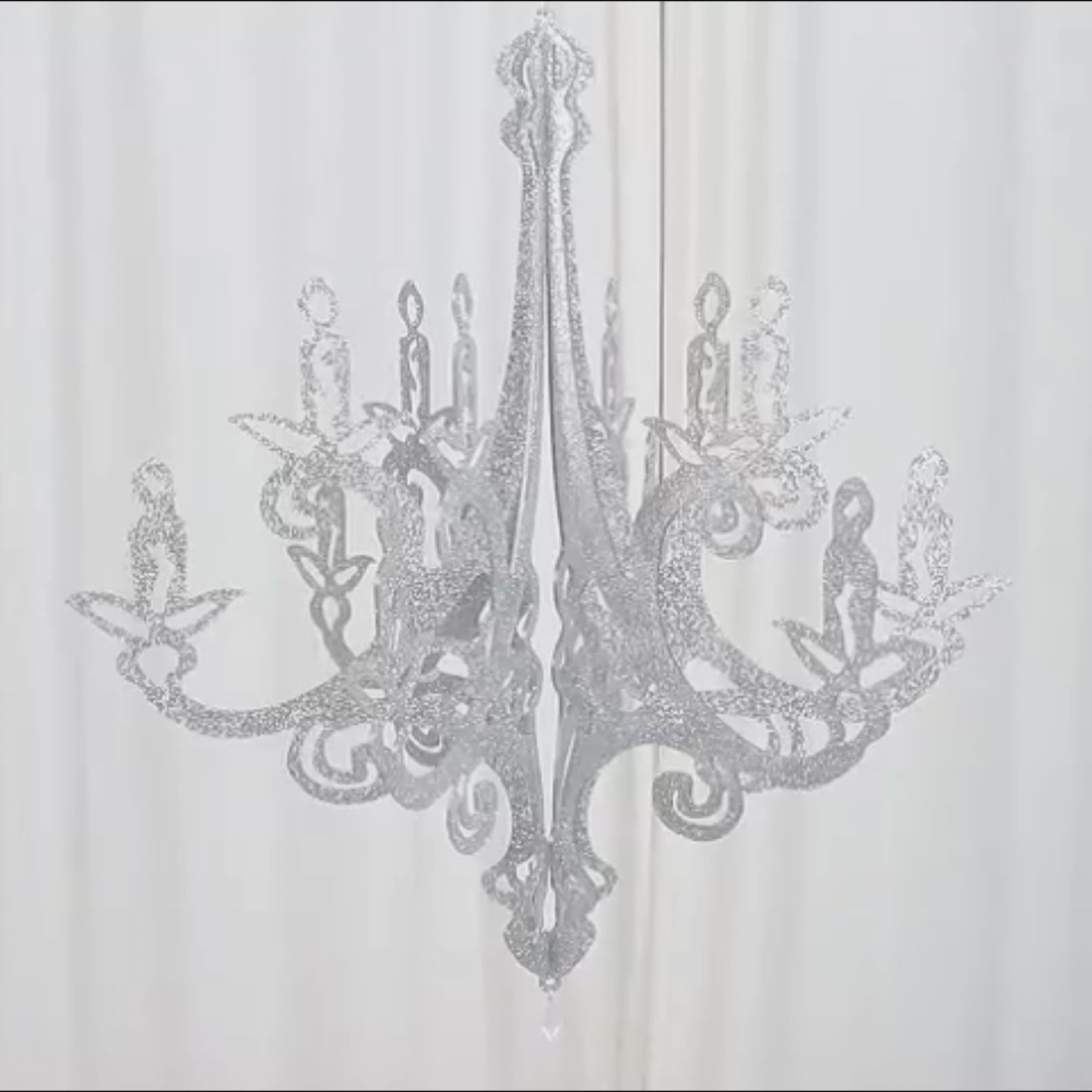 Silver glittered acrylic chandelier hanging decor with a 3D interlocking design.