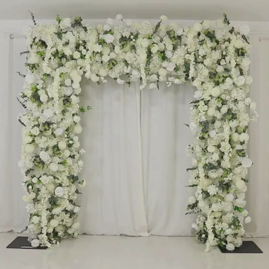 White roll-up flower backdrop with artificial silk roses and hydrangeas.