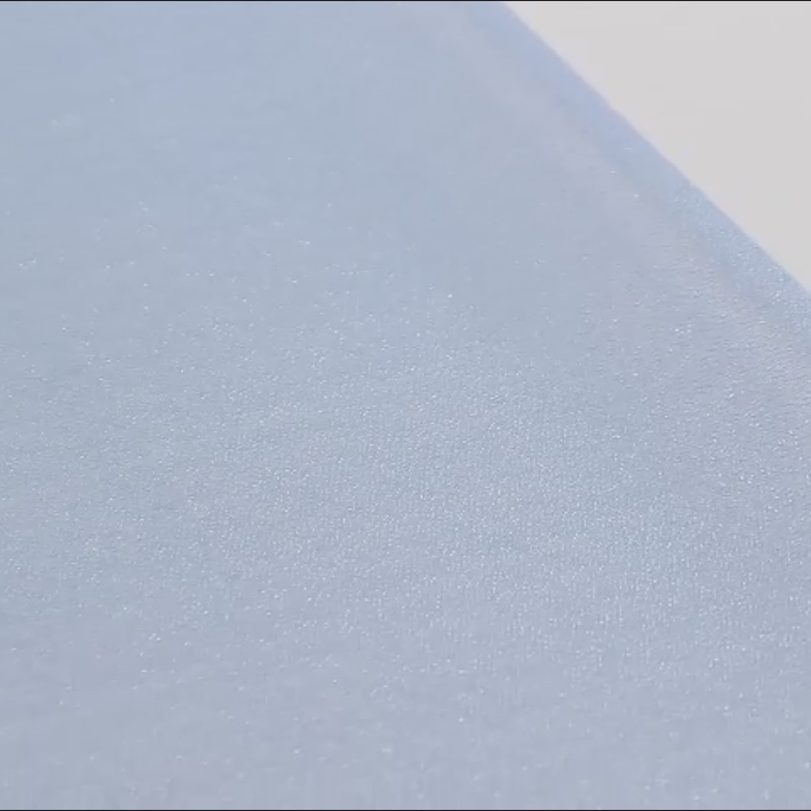 Dusty blue shimmer sheer table runner fabric close-up.