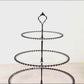 Clear 3-tier dessert display stand with black beaded rim and handle.