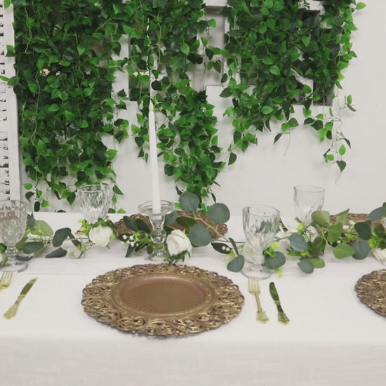 Brown charger plates with vintage floral rim on a decorated table setting.