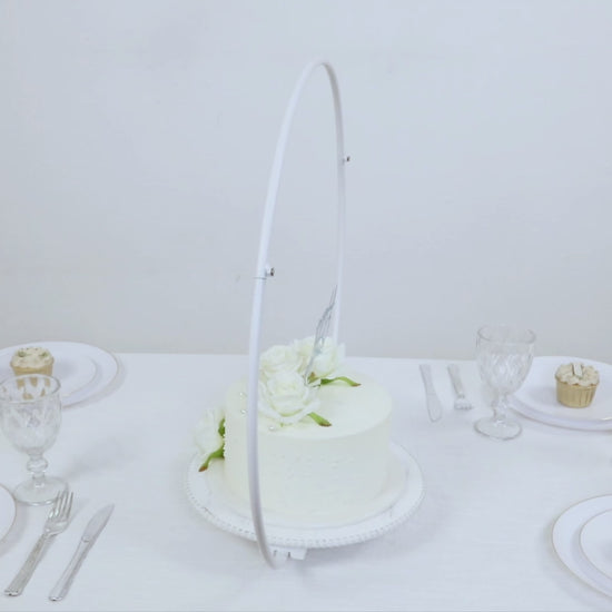 Whitewashed metal floral hoop cake stand with beaded wooden base.