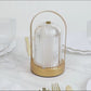 Gold LED table lamp with ribbed acrylic shade, touch control, and cordless design.