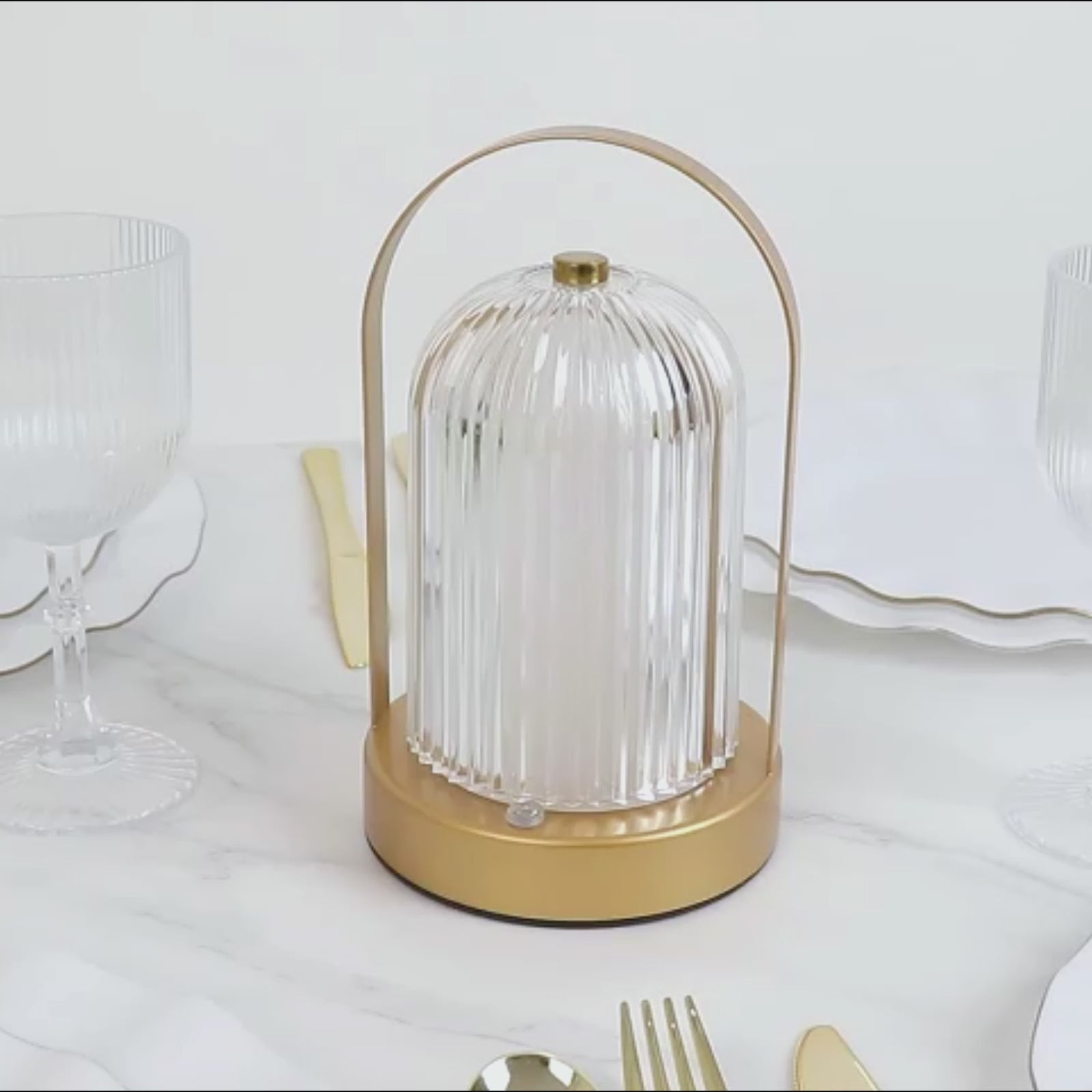 Gold LED table lamp with ribbed acrylic shade, touch control, and cordless design.